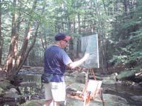 Bernie Ethier paints a large oil painting at his Take It Easel en plein air.  The Take it easel supports his artwork and all his art supplies.